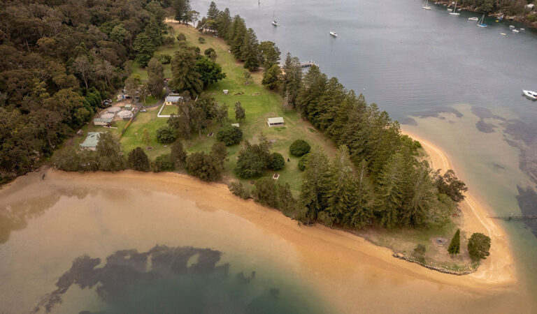 Aerial view of The Basin campground surrounded by The Basin lagoon 768x450